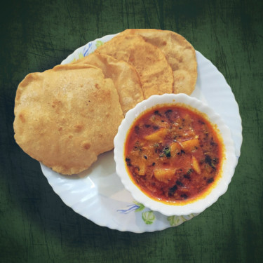 Puri And Spicy Aloo Gravy