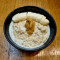 Honey Banana Porridge Served With Coconut Flakes