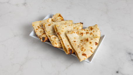 Tandoor Baked Naan Topped With Coconut Flakes And Dried Dates